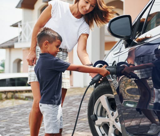 Child charging a electric vehicle